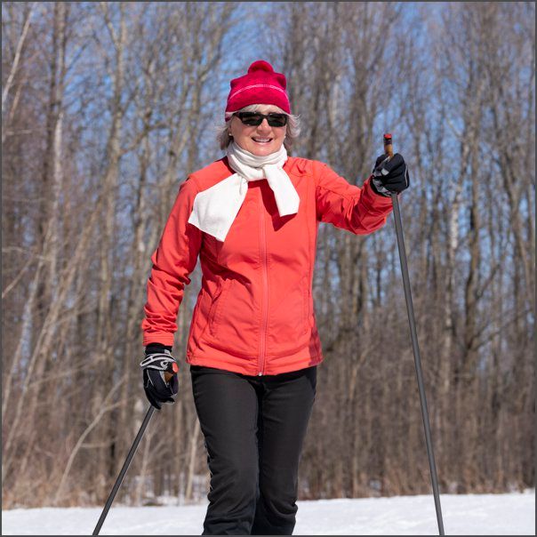 Lady in red outfit cross-country skiing